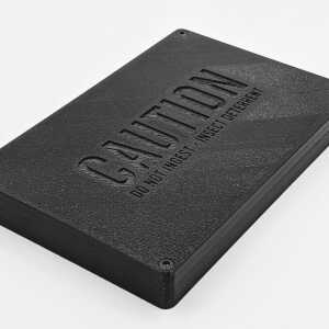 Angled close view of the closed black The Tomb concealed Bitcoin seed plate mount