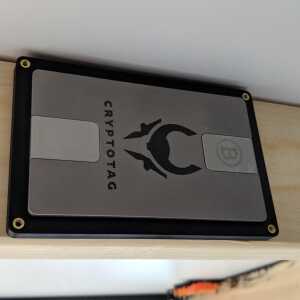 CRYPTOTAG metal Bitcoin seed backup seated in The Tomb hidden wall mount