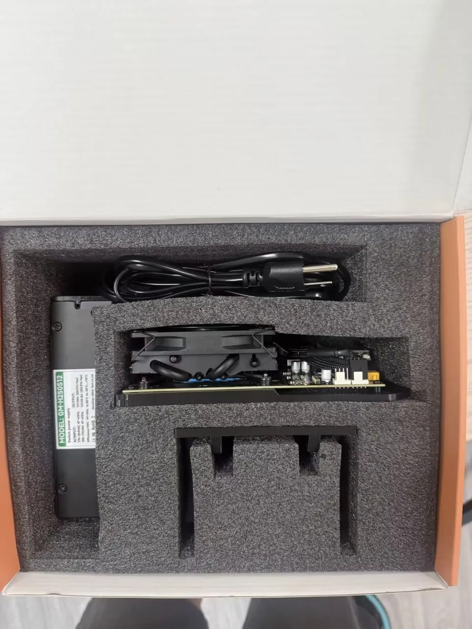 Hammer Miner BC04 package contents with PSU, power cable, miner, and stand in foam box