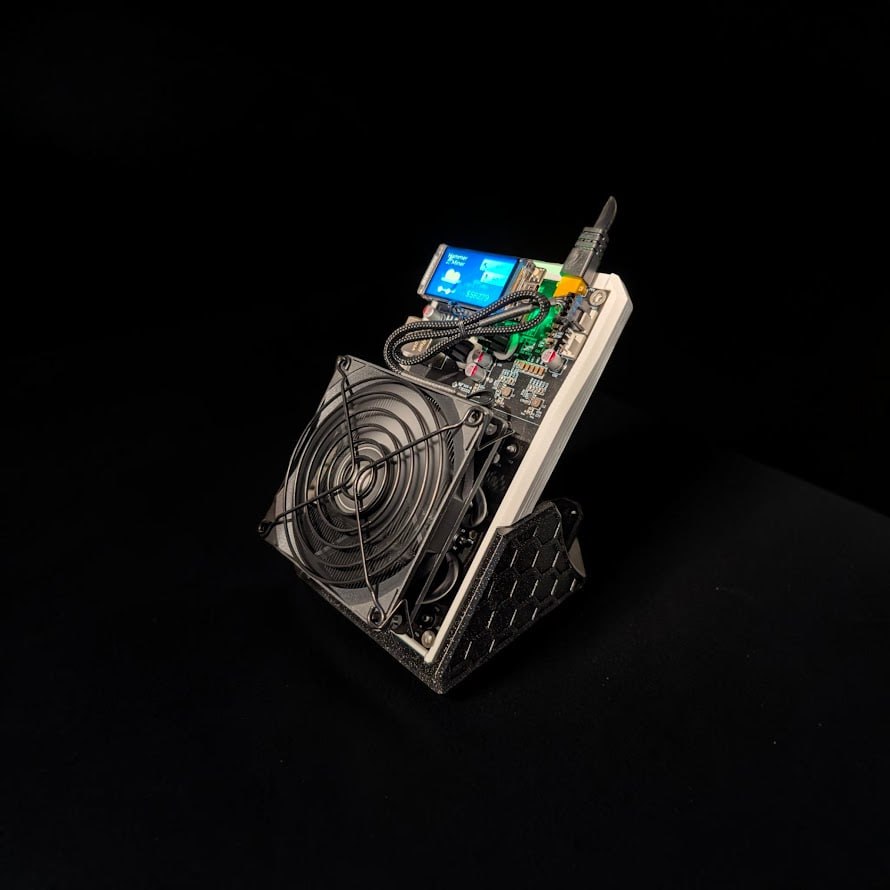 Hammer Miner BC04 Stand holding a BC04 home Bitcoin miner at an angled desktop position