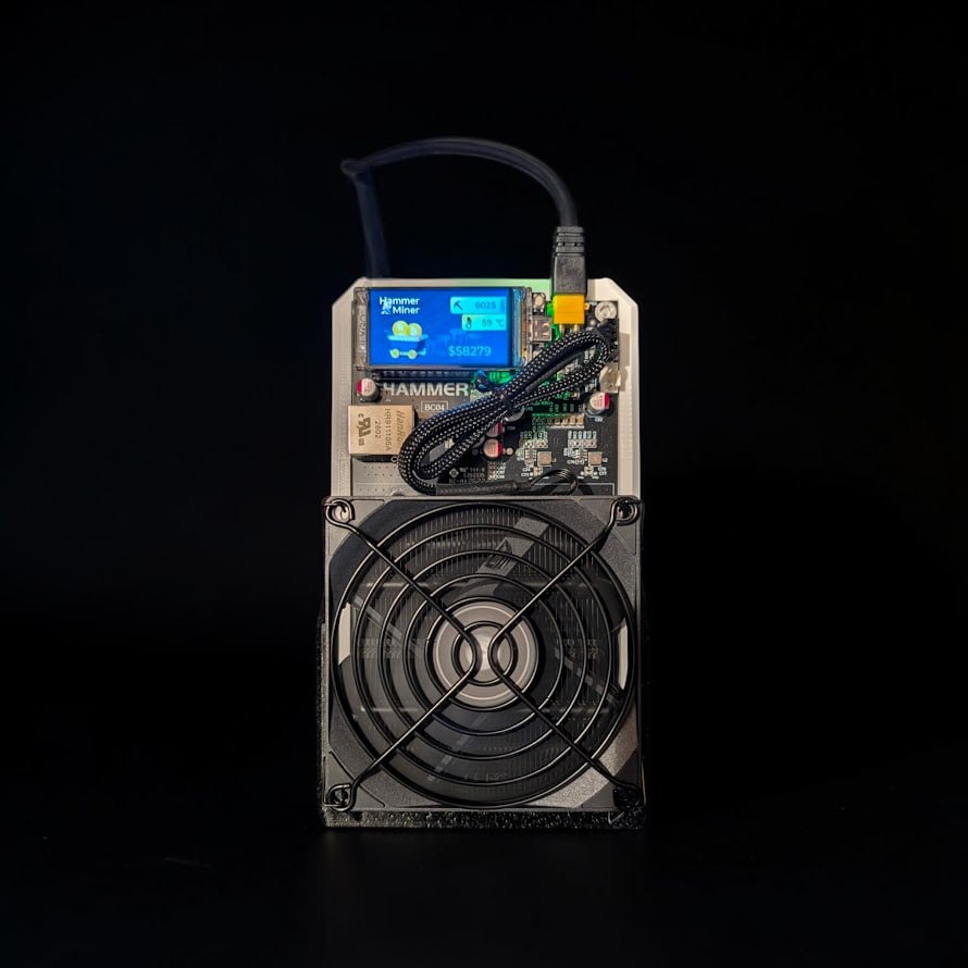 Hammer Miner BC04 in the CryptoCloaks stand with front fan and display visible